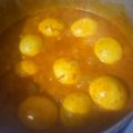 Alexander graham's cooksnap of when they made Egg curry served with white rice and sauted cabbage.