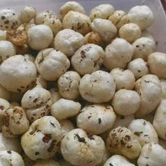 A picture of Makkana tossed in garlic butter with dried herbs.