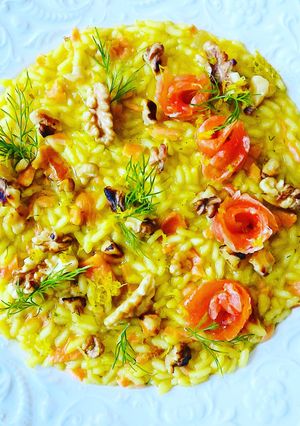 A picture of Saffron Risotto with Smoked Salmon, Toasted Walnuts, and Lemon Zest.