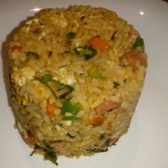 A picture of Spicy vegetable rice with egg and sausage.