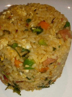 A picture of Spicy vegetable rice with egg and sausage.
