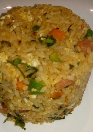 A picture of Spicy vegetable rice with egg and sausage.