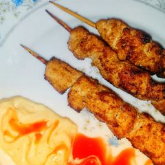 A picture of Orange Chicken skewers.