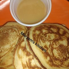 A picture of Pancakes and dulce de leche.