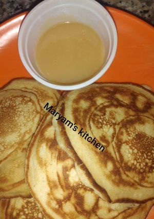 A picture of Pancakes and dulce de leche.