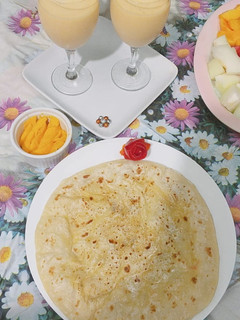 A picture of Daal bhari roti with mango lassi.
