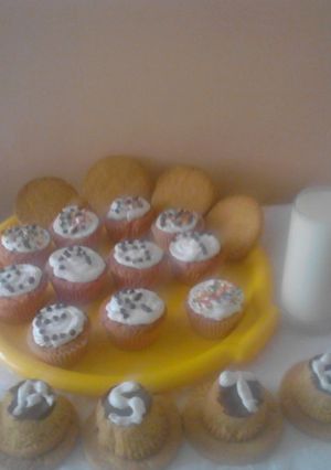 A picture of Cupcakes with cookies,served with fresh milk.