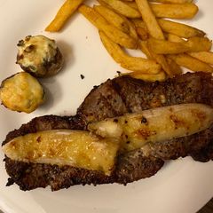 A picture of 🥰Dinner for 2 date night 😍Grilled steak, wt (grilled banana)stuffed spinach mushrooms and fries❤️.