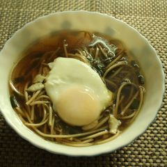 A picture of Spring Onion Noodle soup with Poached egg.