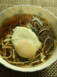 A picture of Spring Onion Noodle soup with Poached egg.