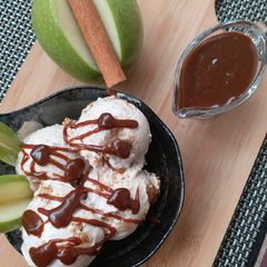 A picture of Apple pie ice cream with caramel sauce.