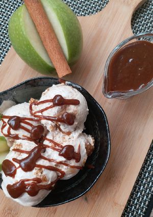 A picture of Apple pie ice cream with caramel sauce.