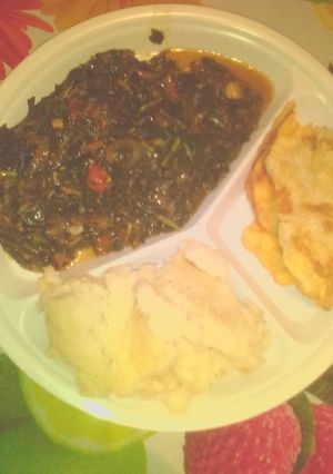 A picture of Ugali served with telele and flied egg.