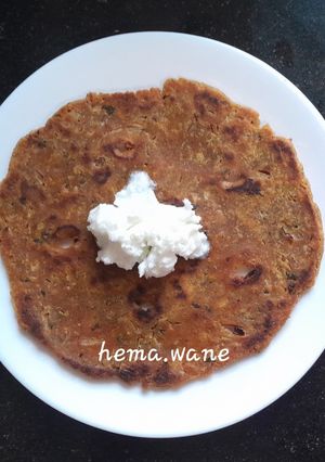 A picture of Arrowroot mix thalipeeth with white butter.