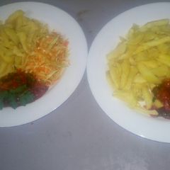 Oven baked fries,salad,tomato onion source A picture of Oven baked fries,salad,tomato onion source.