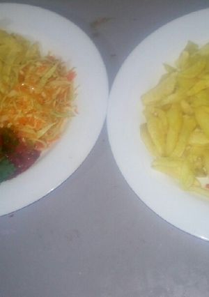 A picture of Oven baked fries,salad,tomato onion source.