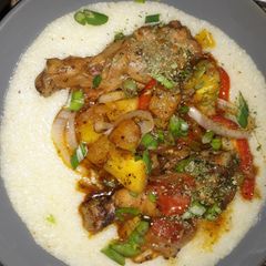 A picture of Sweet & Spicy Pineapple chicken legs on grits.