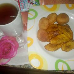 A picture of Akara with fried plantain and lipton.