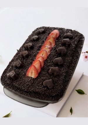 A picture of Chocolate Cake with Sweetened Condensed Milk Cream and Strawberries.