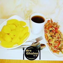 A picture of Boiled irish potatoes with sauce and black tea.