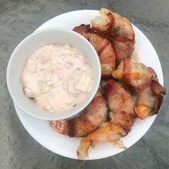 A picture of Bacon-Wrapped Stuffed Shrimp w/ Sauce.