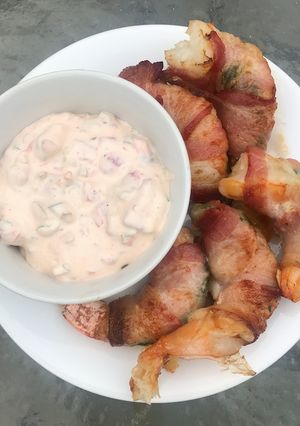 A picture of Bacon-Wrapped Stuffed Shrimp w/ Sauce.