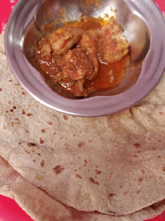 A picture of Roti with chicken salan.