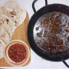 A picture of Wok spinach pork, naan and tomato pickle🍅🧄🧅🥬🌶️.
