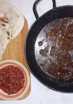 A picture of Wok spinach pork, naan and tomato pickle🍅🧄🧅🥬🌶️.