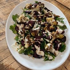 Spring greens, air fried cauliflower and beetroot salad with tahini dressing A picture of Spring greens, air fried cauliflower and beetroot salad with tahini dressing.