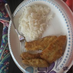 A picture of Breaded fish with rice and cauliflower.