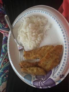 A picture of Breaded fish with rice and cauliflower.