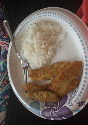 A picture of Breaded fish with rice and cauliflower.