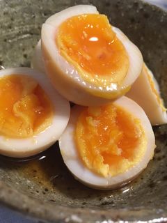 A picture of Soft boiled eggs marinated in soy sauce and mirin.