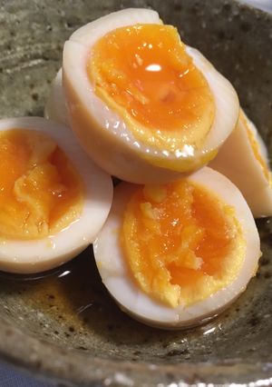 A picture of Soft boiled eggs marinated in soy sauce and mirin.