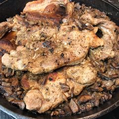 A picture of Baked pork chops and rice.