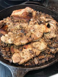 A picture of Baked pork chops and rice.