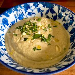 A picture of Almendras Soup with spiced almonds and cauliflower.