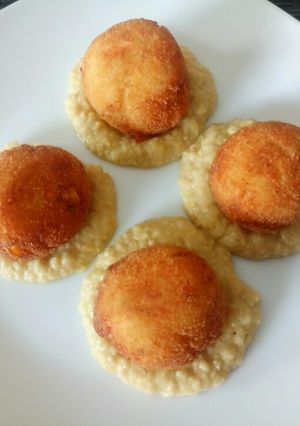 A picture of Deep fried salmon and corn balls with hummus.