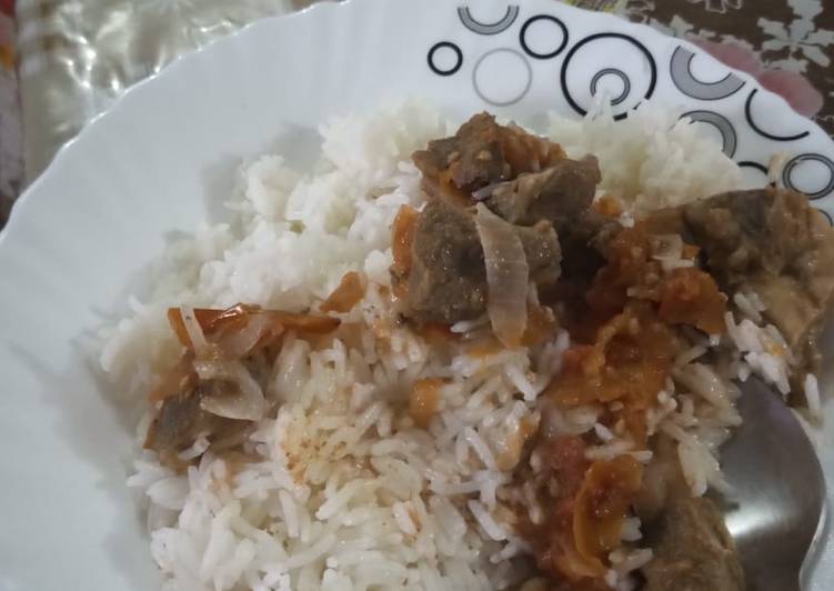 Coconut rice with goat meat stew