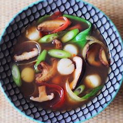 A picture of Shiitake Dashi with quick cooked scallops.