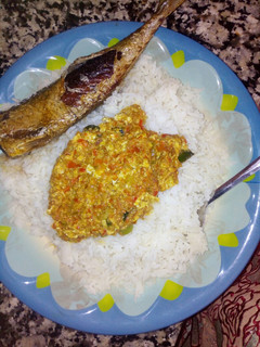 A picture of White rice with egg souce.