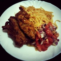 A picture of Pan fried chi with noodles and kachumbari.