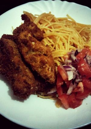 A picture of Pan fried chi with noodles and kachumbari.