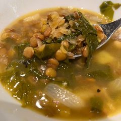 A picture of Lebanese style lemony brown lentil, potato and spinach soup.