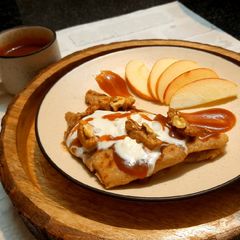A picture of WALNUT APPLE PARATHA WITH CARAMEL SAUCE & VANILLA ICE-CREAM.
