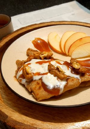 A picture of WALNUT APPLE PARATHA WITH CARAMEL SAUCE & VANILLA ICE-CREAM.
