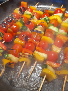 A picture of Side dish, vibrant vegetable skewers.