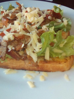 A picture of Tiger bread toast with roast beef and tomatoes.