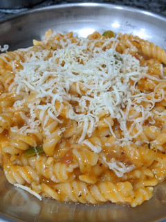A picture of Pasta in white and red sauce.